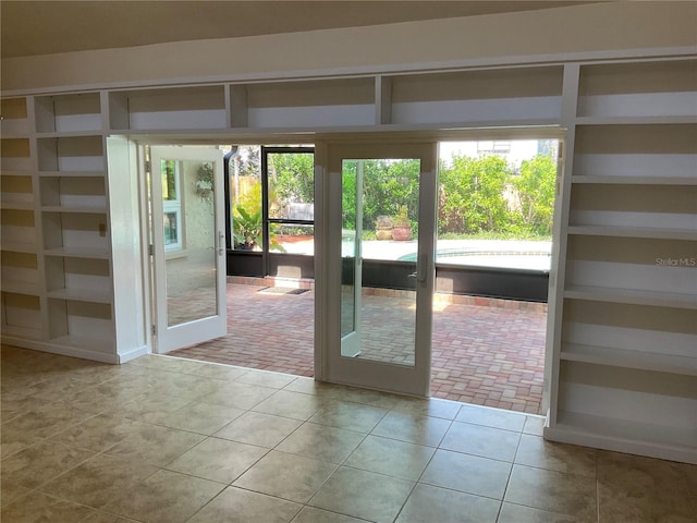 doorway with tile patterned flooring and french doors