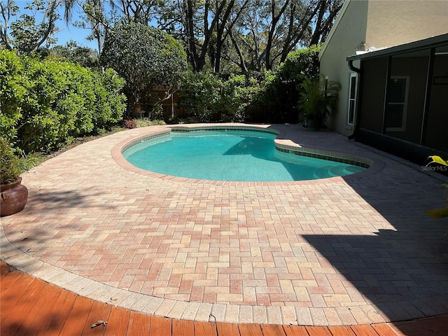 pool featuring a patio area and fence