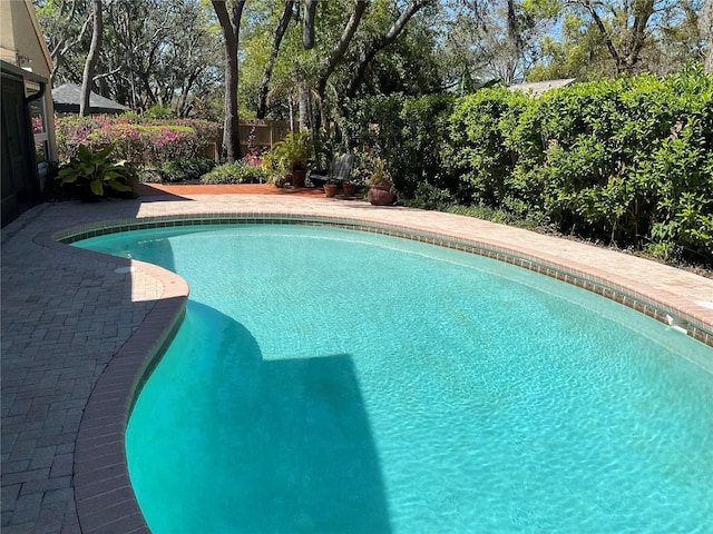 outdoor pool featuring a fenced backyard