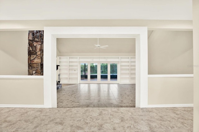 11712 Palmer Dr, Tampa, FL 33624 - spare room with a ceiling fan, built in shelves, and a fireplace