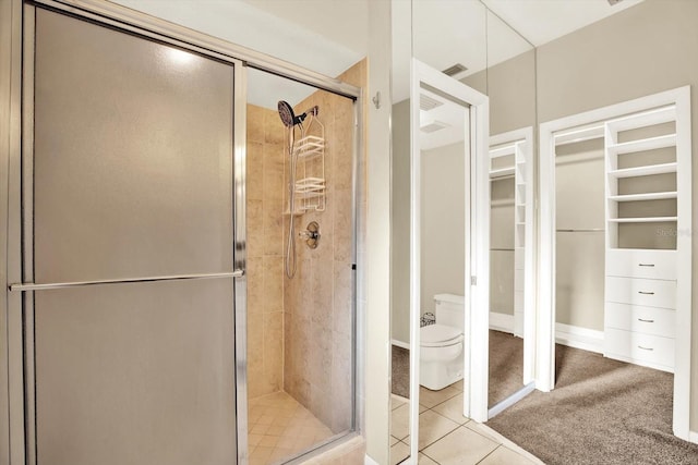 11712 Palmer Dr, Tampa, FL 33624 - bathroom with a stall shower, a spacious closet, and tile patterned flooring