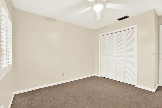 11712 Palmer Dr, Tampa, FL 33624 - unfurnished bedroom featuring carpet flooring, a closet, and a ceiling fan