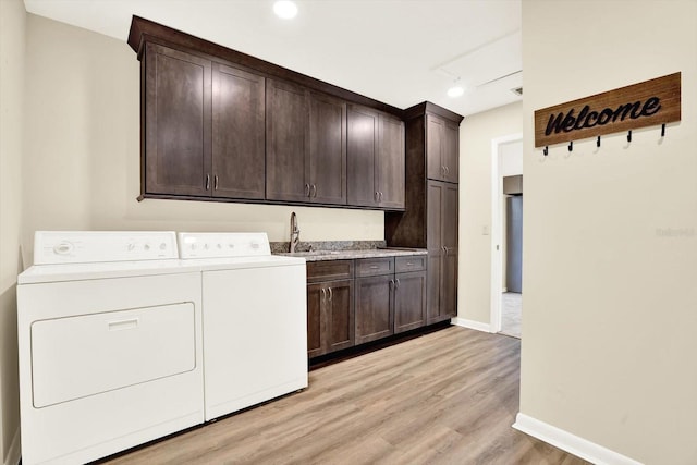 11712 Palmer Dr, Tampa, FL 33624 - laundry area with cabinet space, washing machine and clothes dryer, light wood finished floors, and track lighting
