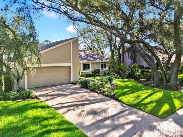 11712 Palmer Dr, Tampa, FL 33624 - mid-century inspired home with stucco siding, an attached garage, decorative driveway, a front lawn, and roof with shingles