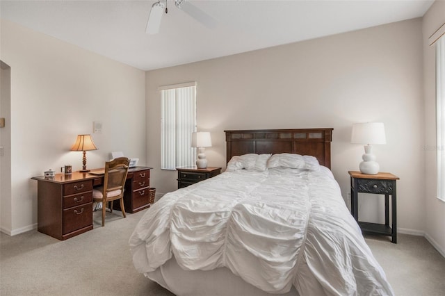 bedroom with light carpet, ceiling fan, and baseboards