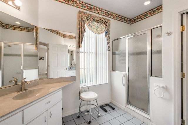 bathroom with baseboards, a shower stall, vanity, and tile patterned floors