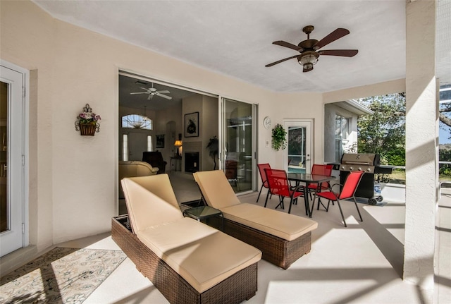 view of patio with ceiling fan, outdoor dining area, and grilling area