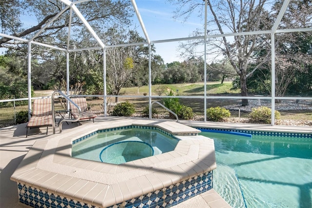 view of pool with a patio, a lanai, and a pool with connected hot tub