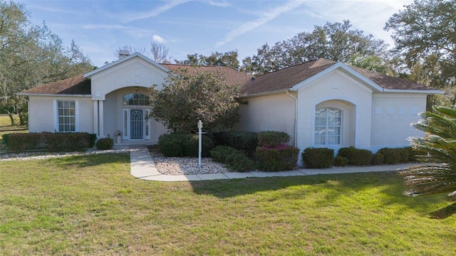 view of front of home with a front lawn and stucco siding