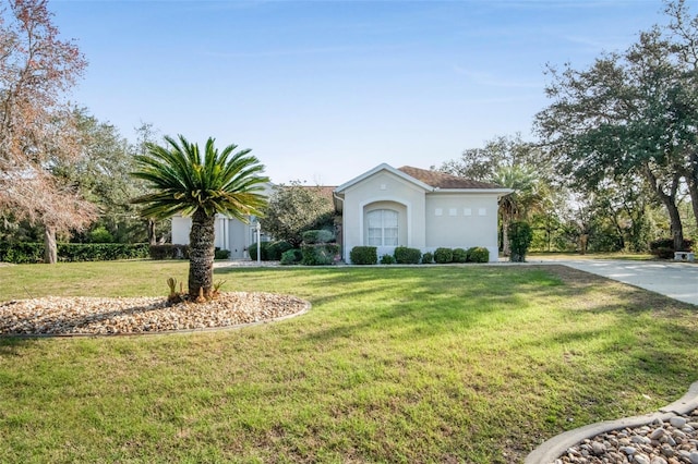 view of front of home with a front yard and stucco siding