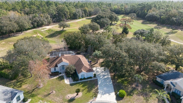 bird's eye view with a wooded view