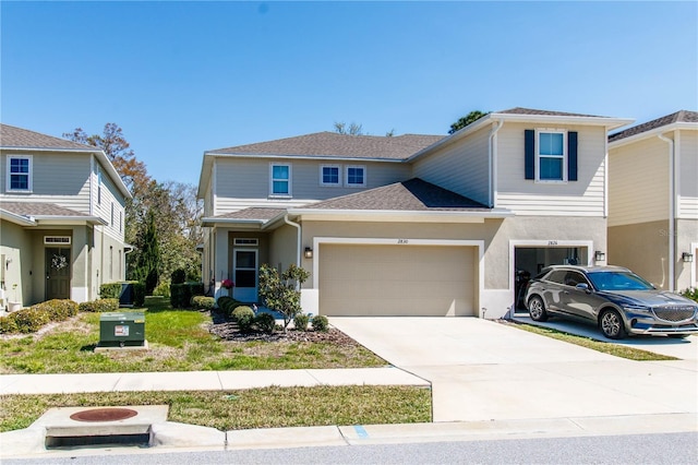 view of front of property with stucco siding, driveway, and roof with shingles