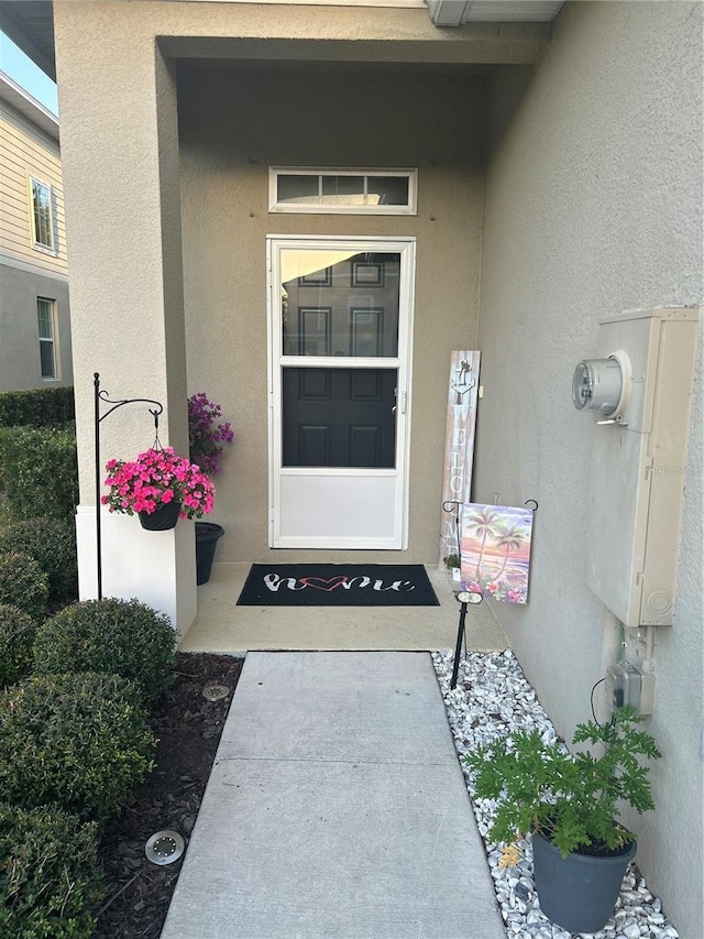 property entrance with stucco siding