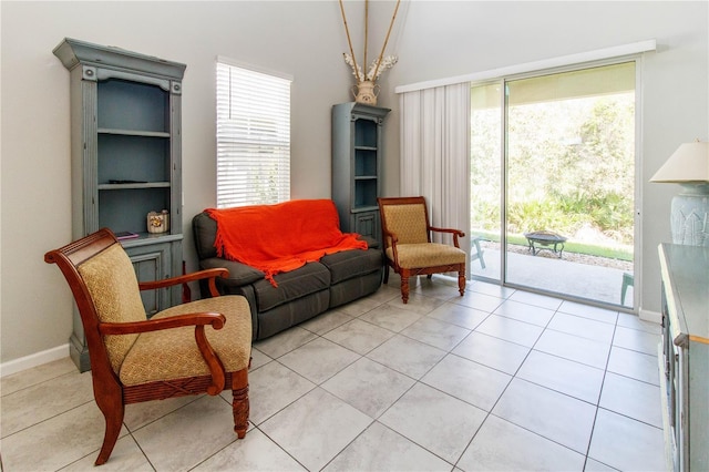 sitting room with light tile patterned floors and baseboards