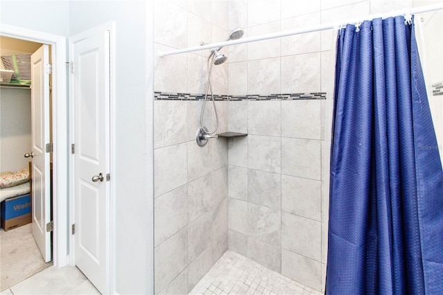 bathroom with tile patterned floors and a stall shower