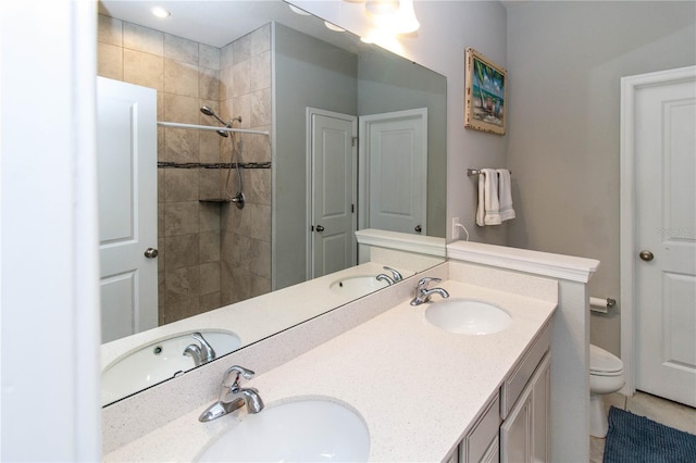 bathroom featuring a sink, toilet, and double vanity