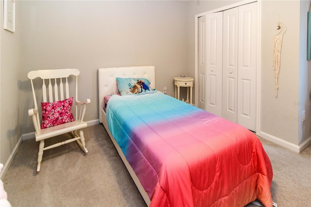 bedroom with a closet, carpet flooring, and baseboards