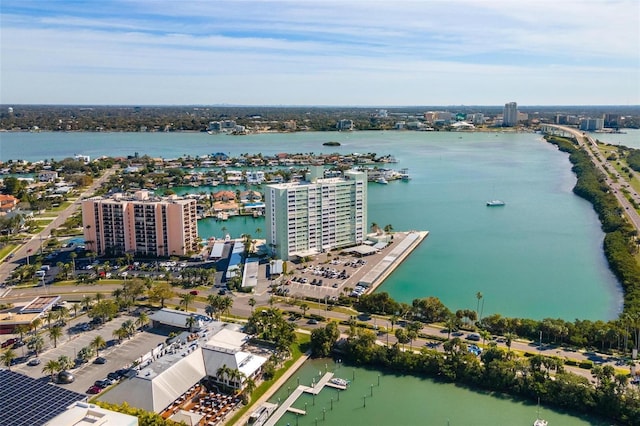 drone / aerial view featuring a city view and a water view