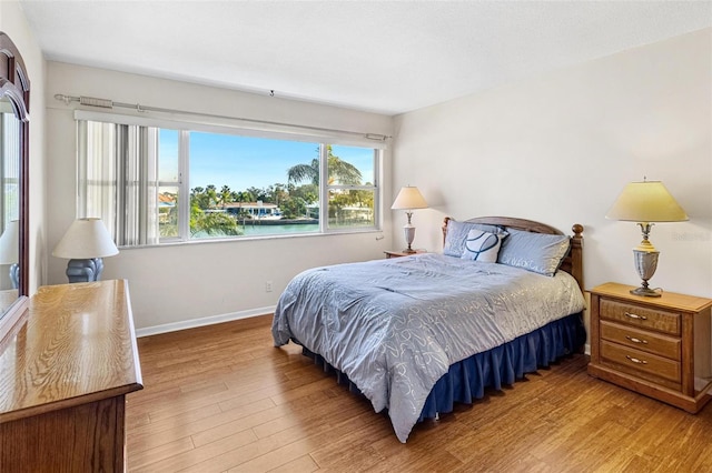 bedroom featuring baseboards and wood finished floors