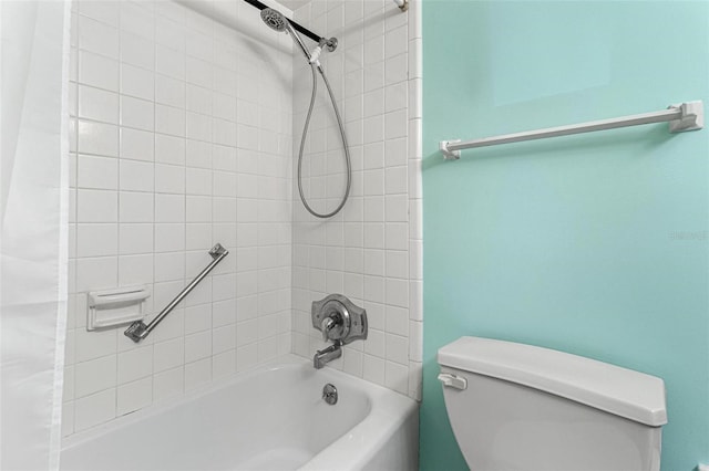 bathroom featuring toilet and shower / tub combo with curtain