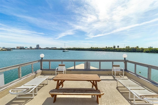 exterior space featuring a balcony and a water view