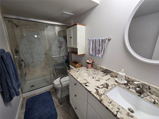 bathroom with a shower stall, toilet, and vanity