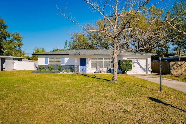 ranch-style home featuring a garage, fence, concrete driveway, stucco siding, and a front yard