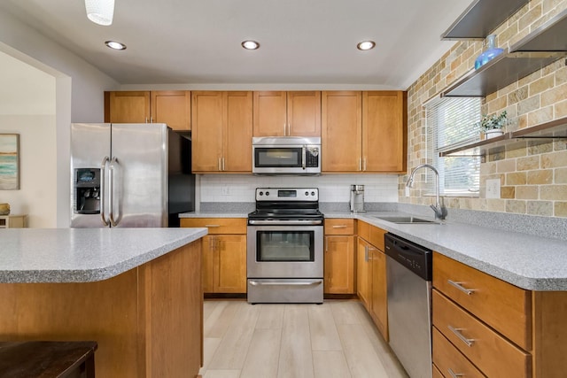 kitchen with stainless steel appliances, a sink, light wood-type flooring, backsplash, and open shelves