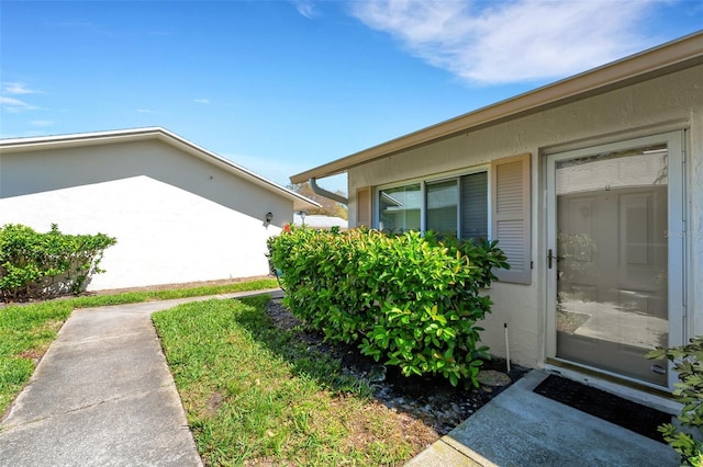 view of side of home with stucco siding