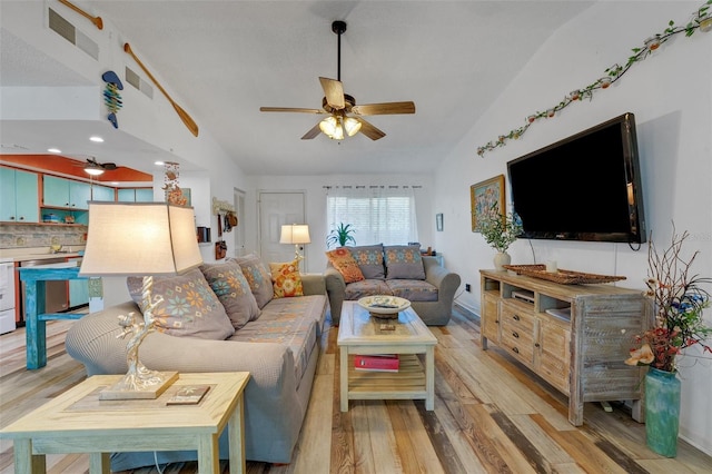 living room with light wood-style floors, lofted ceiling, visible vents, and ceiling fan