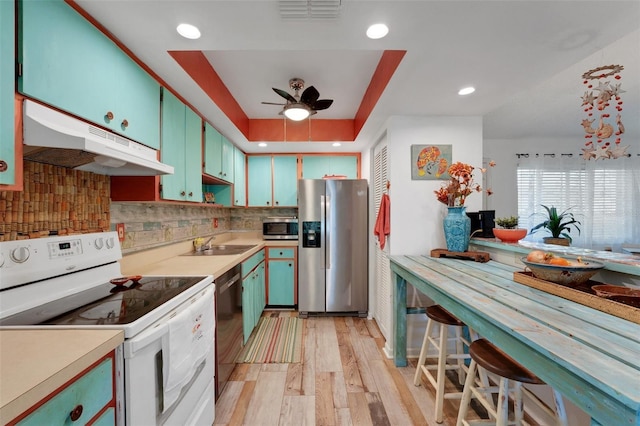 kitchen featuring under cabinet range hood, visible vents, appliances with stainless steel finishes, and light countertops