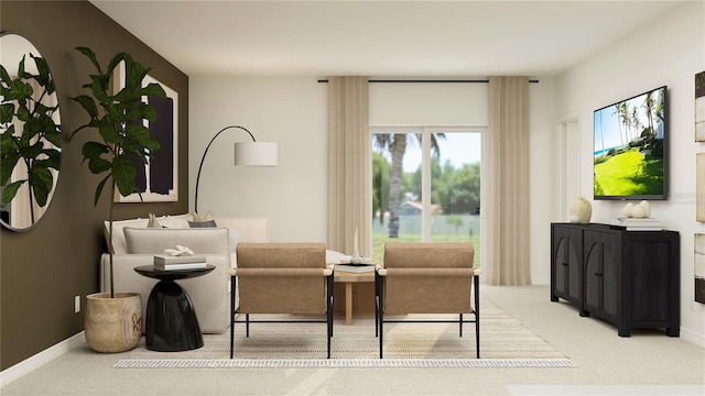 sitting room featuring carpet and baseboards