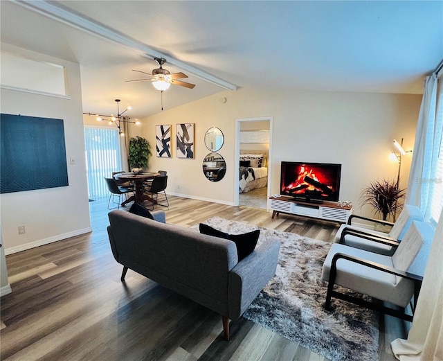 living room with lofted ceiling with beams, wood finished floors, and baseboards