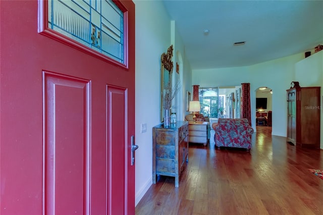 entrance foyer with visible vents, baseboards, and wood finished floors