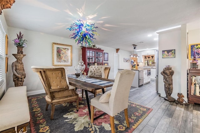 dining area with light wood-style flooring and baseboards