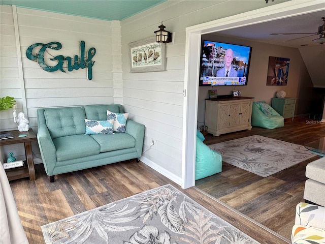 living area featuring a ceiling fan and wood finished floors