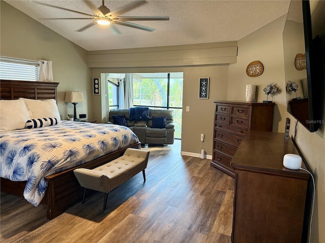 bedroom featuring ceiling fan, a textured ceiling, dark wood-style flooring, access to exterior, and vaulted ceiling