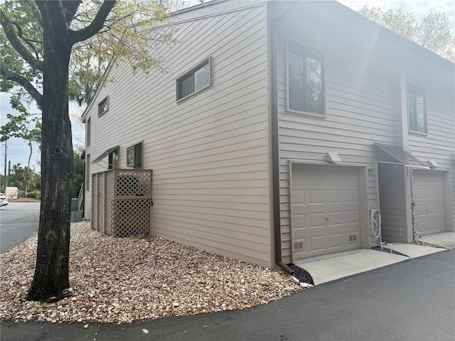 view of home's exterior with driveway and a garage