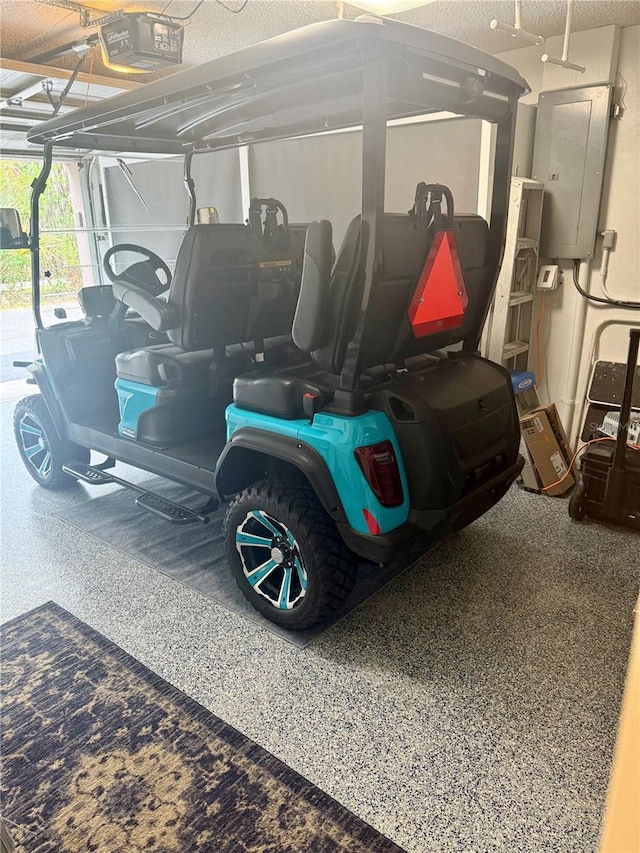 garage with electric panel and a garage door opener