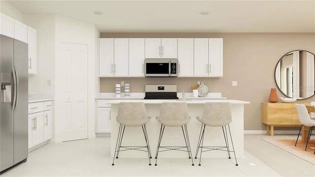 kitchen with white cabinets, a kitchen island, appliances with stainless steel finishes, a breakfast bar area, and light countertops