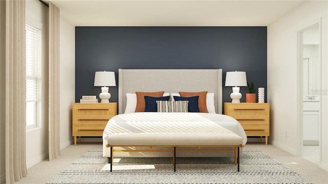 bedroom featuring light carpet, an accent wall, and baseboards