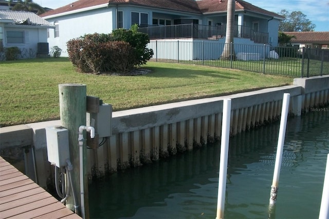 view of property exterior featuring a lawn, fence, and stucco siding