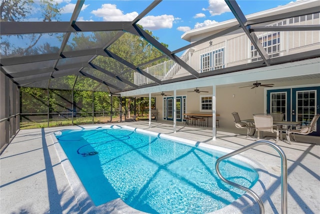 outdoor pool with a lanai, ceiling fan, french doors, and a patio