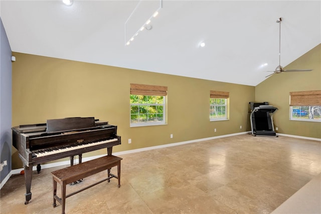 living area featuring track lighting, ceiling fan, high vaulted ceiling, and baseboards