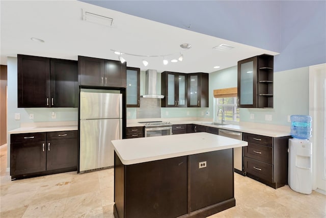 kitchen featuring open shelves, a center island, appliances with stainless steel finishes, wall chimney exhaust hood, and a sink