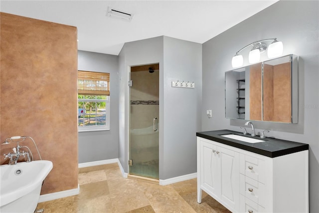 bathroom featuring a freestanding tub, visible vents, a stall shower, baseboards, and vanity