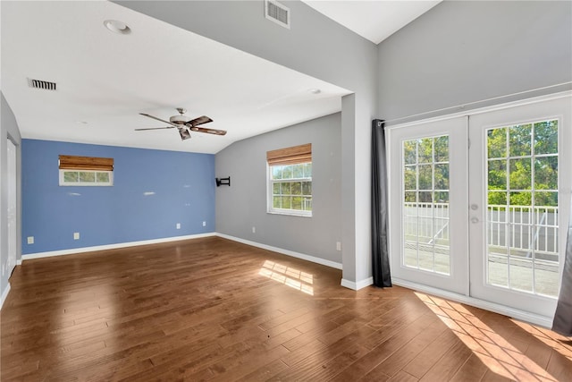 empty room featuring wood finished floors, visible vents, french doors, and baseboards