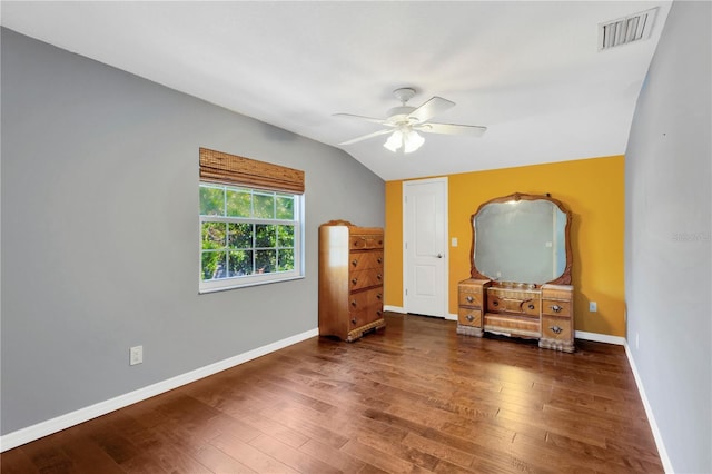 bedroom with visible vents, baseboards, lofted ceiling, wood finished floors, and a ceiling fan