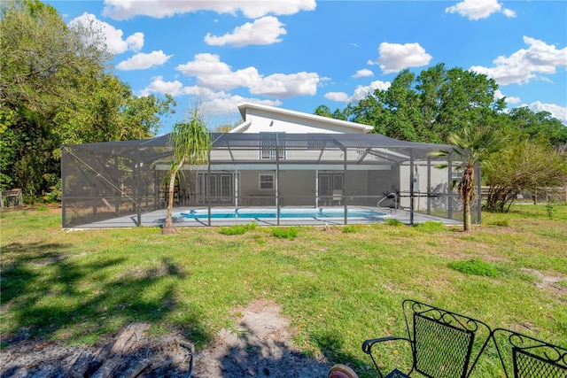 view of yard with glass enclosure and an outdoor pool