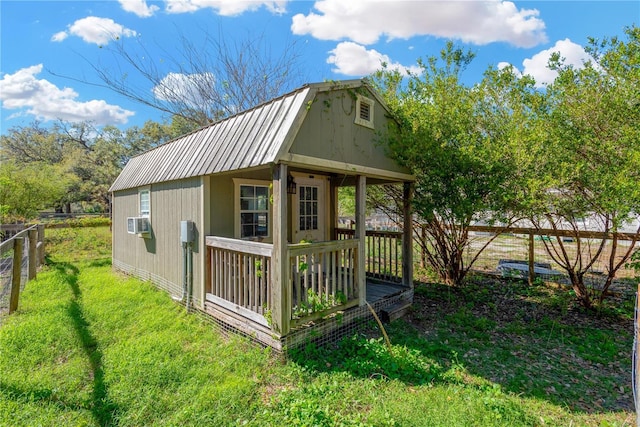 view of outbuilding featuring cooling unit, an outdoor structure, and fence